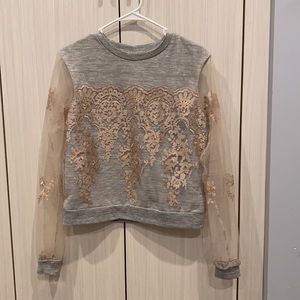 Sweater with transparent sleeves and golden design